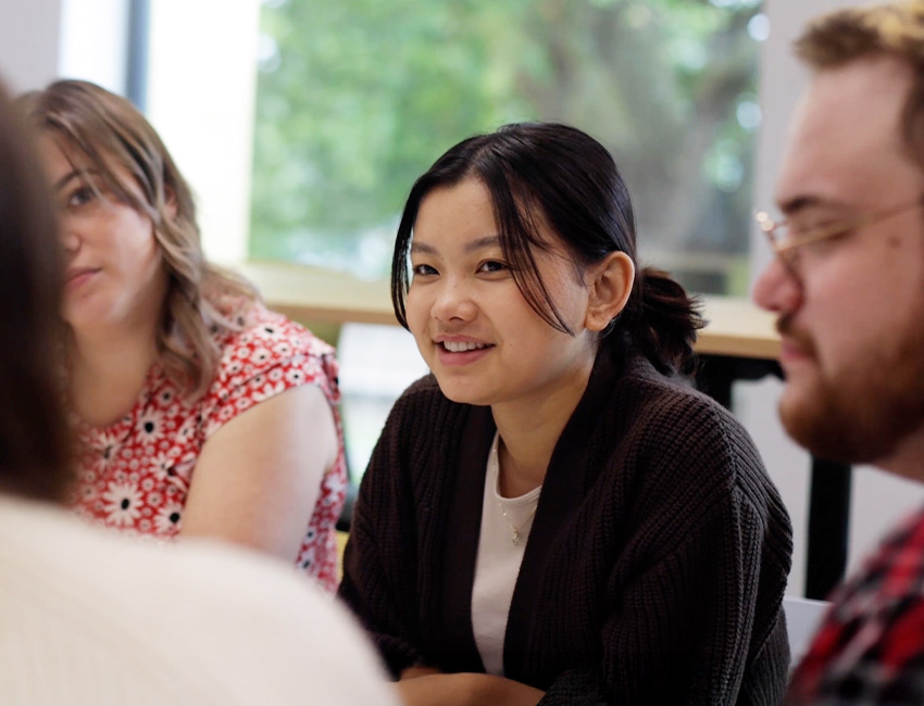 A group of students talking as part of a writing workshop
