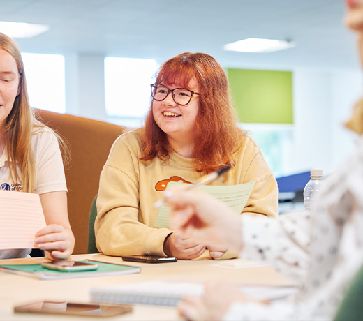 A group of students studying with flash cards together