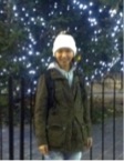 out of focus picture of a woman in a bobble hat and green jacket