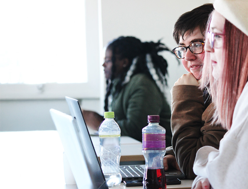 Students working on their laptops at a table