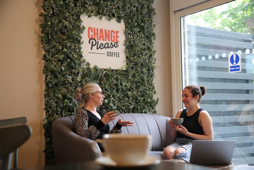 Two students having a chat in a campus cafe
