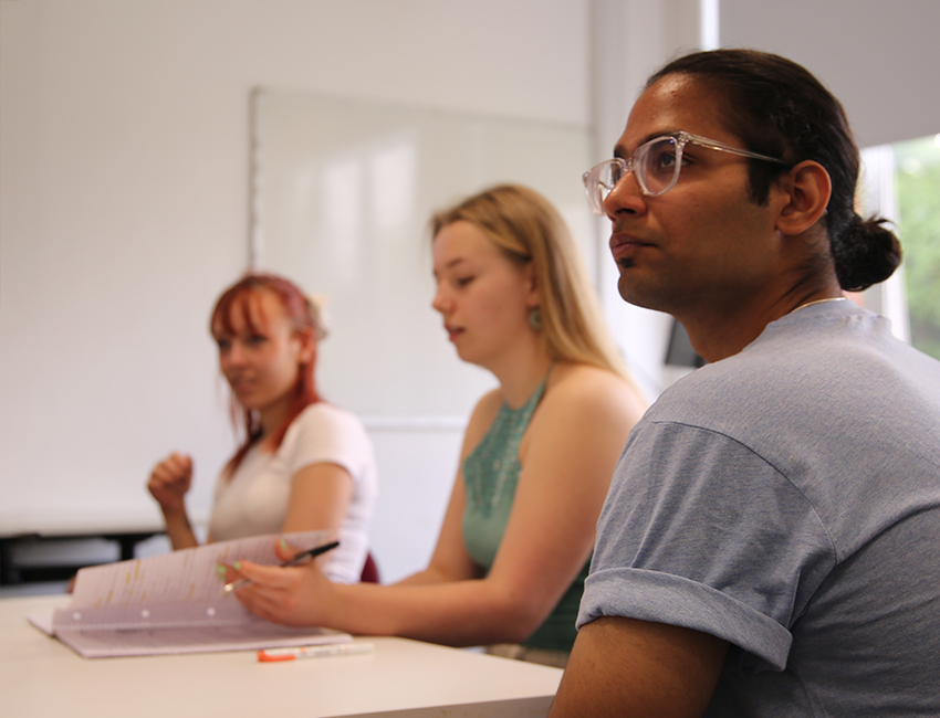 Three people in a lecture