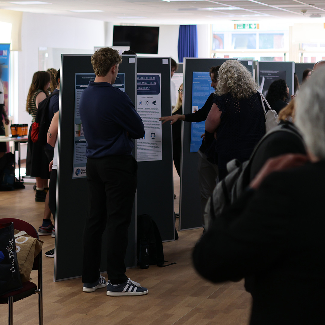 Visitors looking at students' criminology conference displays