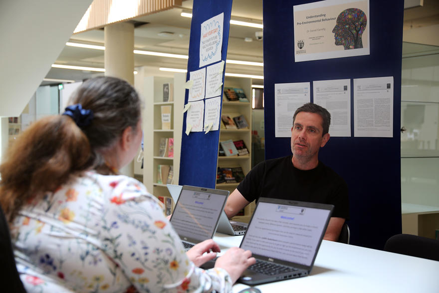 Dr  Daniel Farreley speaks to an attendee of the event