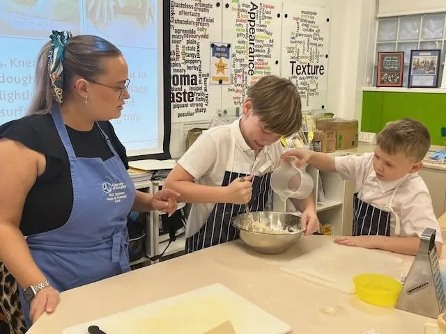 A student teaching two primary school children