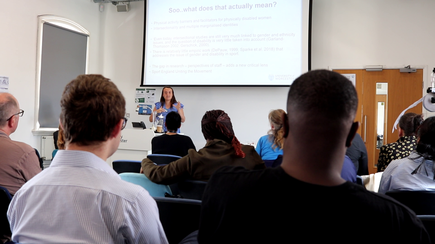 A speaker delivering a talk to a room of people
