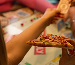 A girl with a slice of pizza