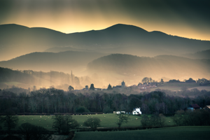View of the Malvern Hills across a field on a misty morning