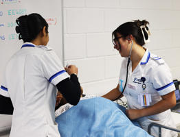 Two nursing students with dummy patient