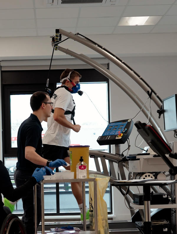 Alfie Pritchard on a running machine hooked up to a machine analysing his breathing