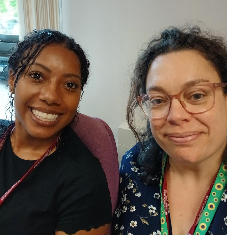 Amy and Chanika smile for the camera while posing together