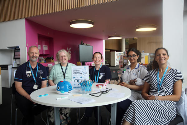 hildren's Nursing staff and students around a table at The Hive library