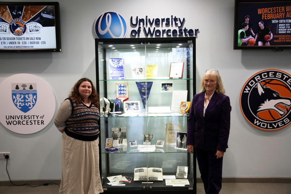 Katy Small and Theresa Oakley pose next to the new cabinet