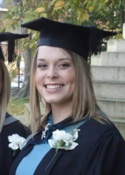 A head and shoulders shot of a female graduate in a cap and gown.