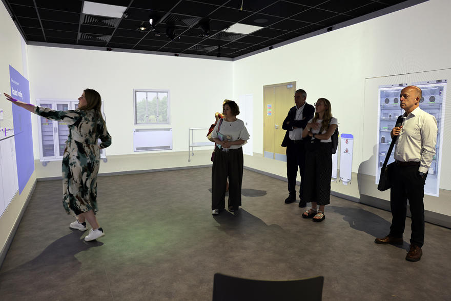 Five people looking around an immersive education suite with touch sensitive walls