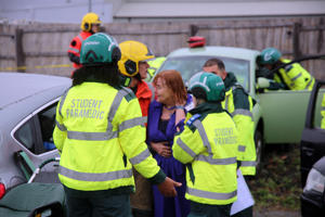 Paramedics support a casualty actor