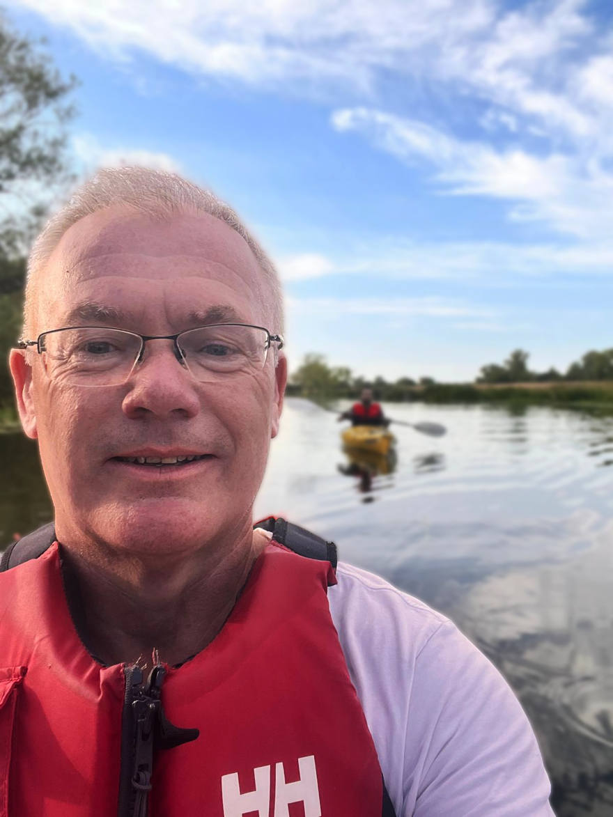 Steve Ennis  takes a selfie wearing a lifejacket in a kayak