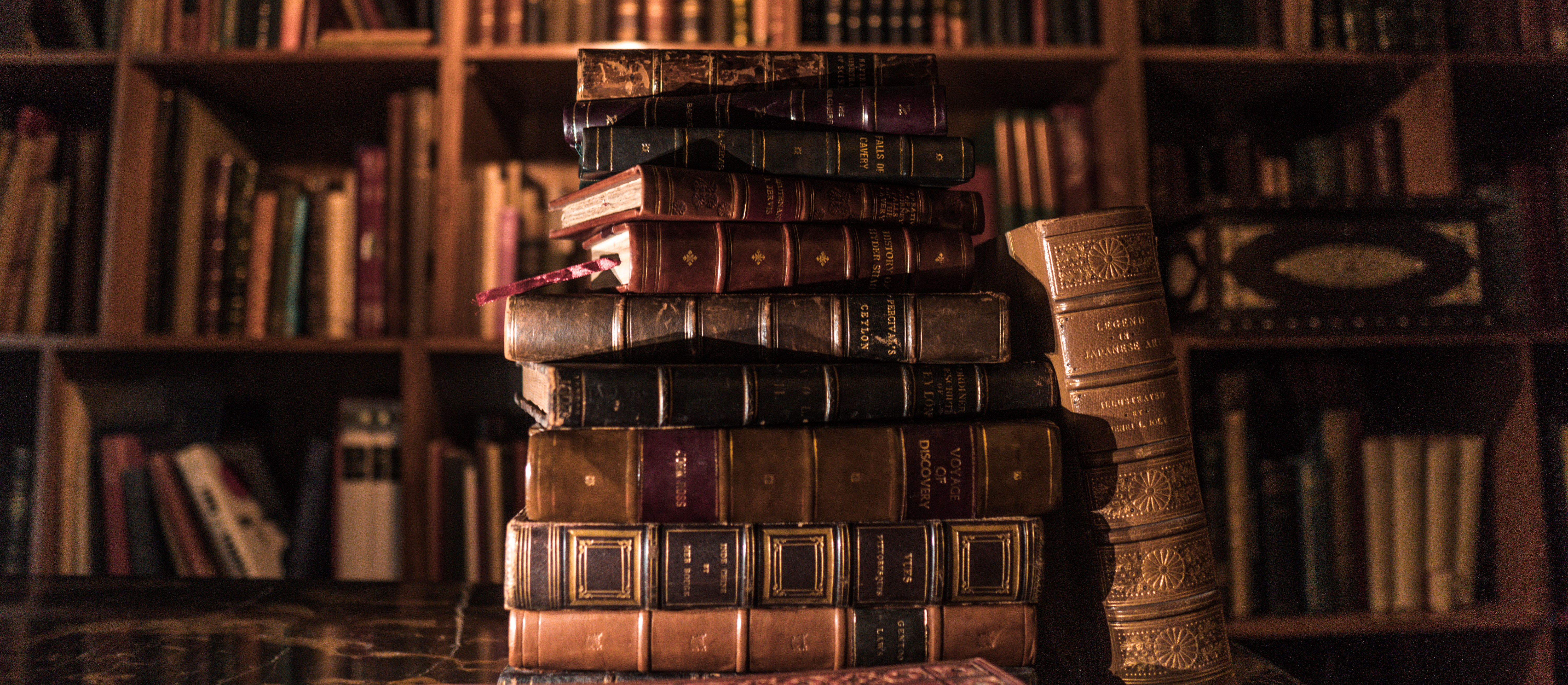A pile of old leather bound books