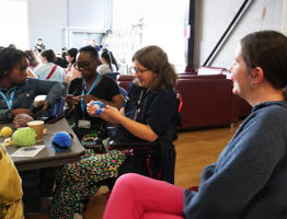 Students making pompoms in the SU