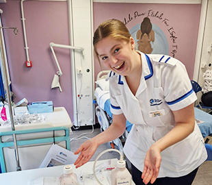 A student in midwifery uniform- white with blue stripes