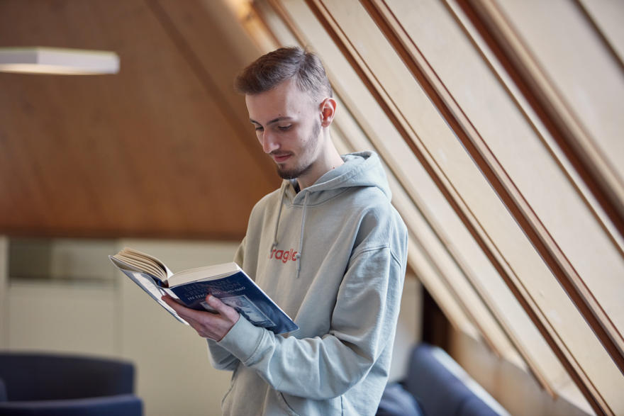 A student reading a book in The Hive