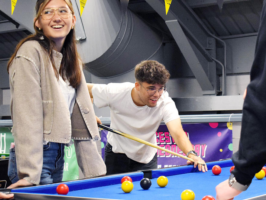 Students playing pool in the Hangar