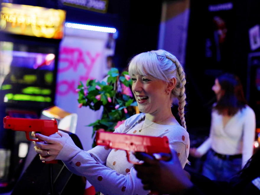 Student enjoying herself in an arcade environment