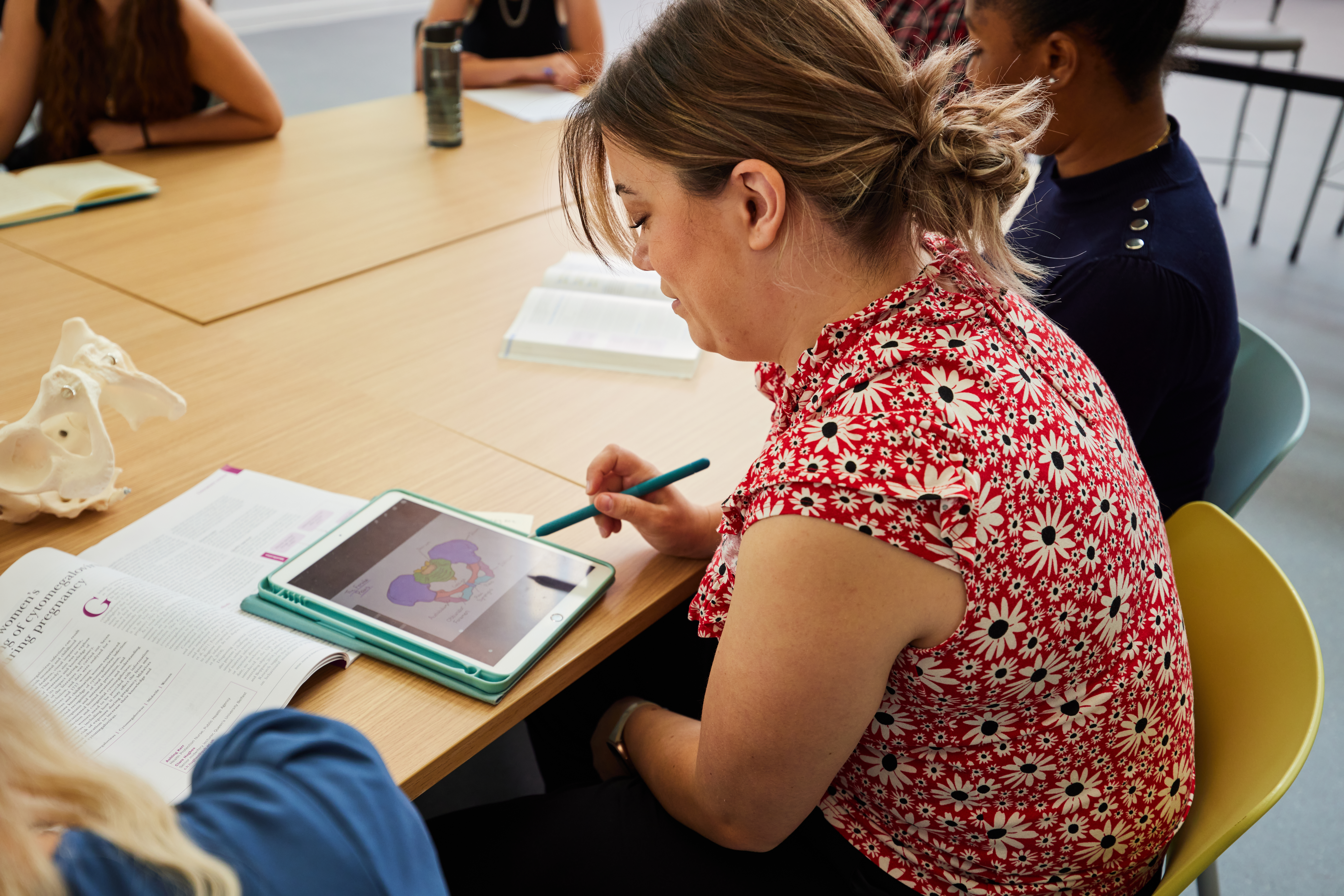 Student making notes on an ipad