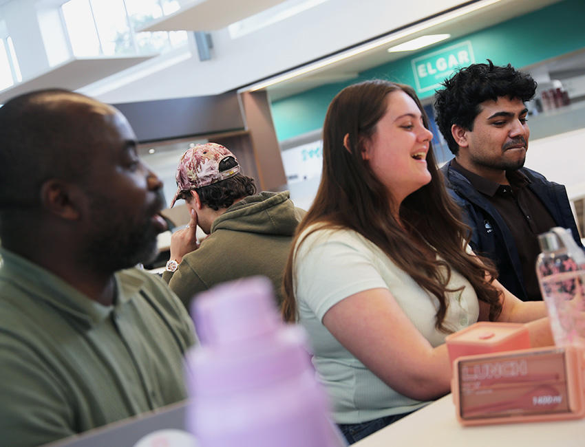 Students playing a card game in canteen