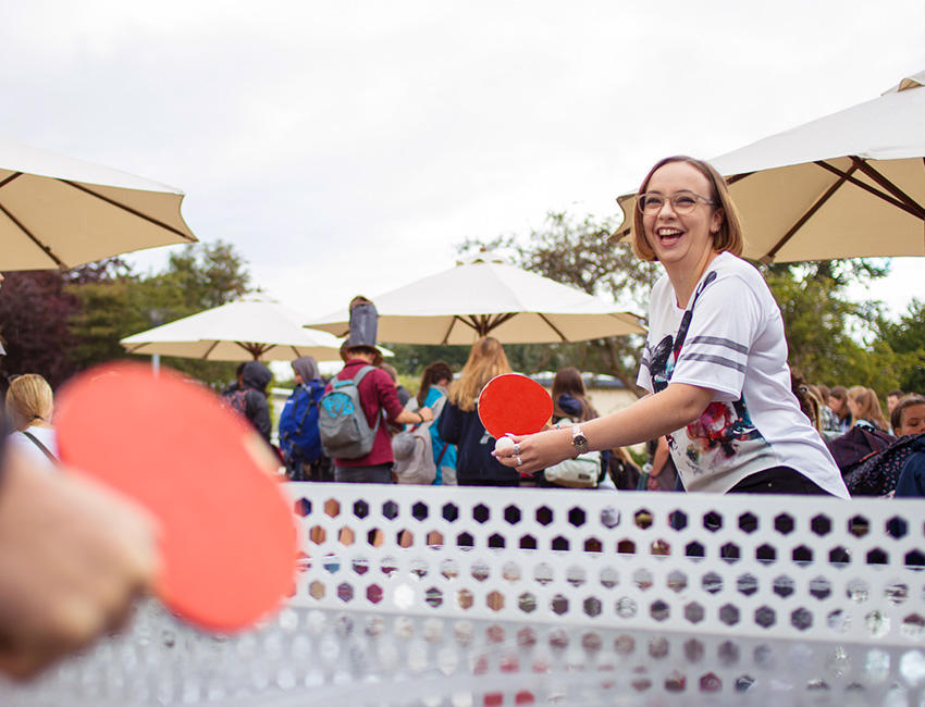 Students playing table tennis in the SU Quad