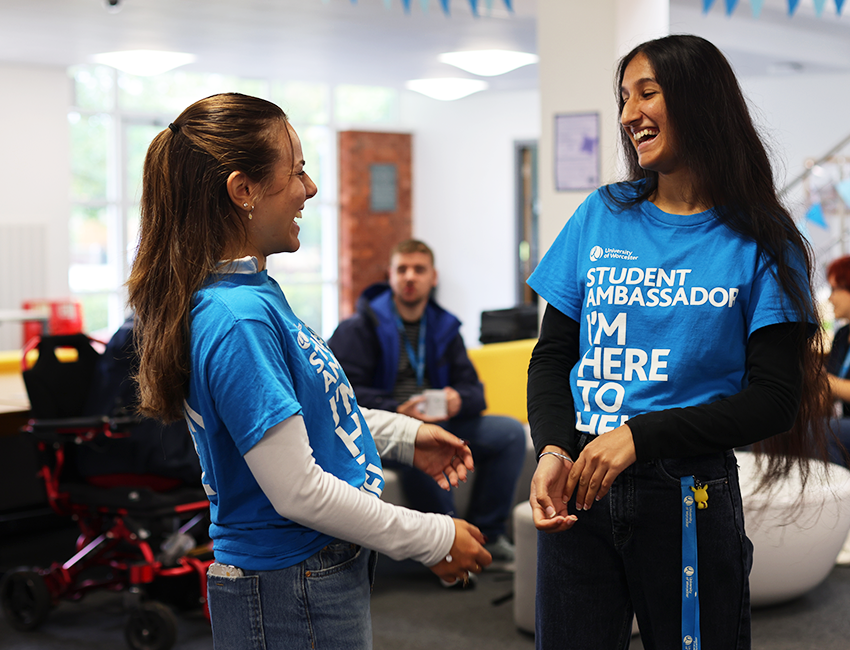 Two students in blue student ambassador tops