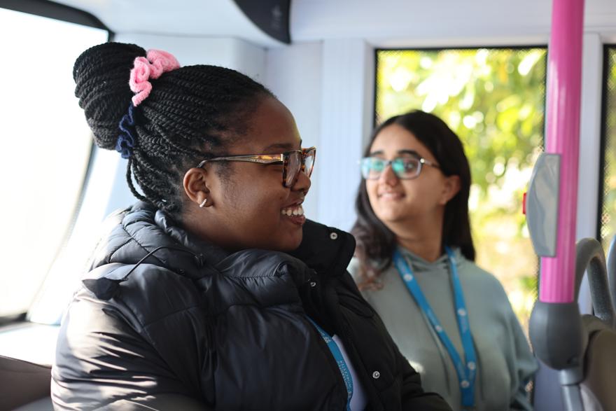 Two students sat at the back of a bus