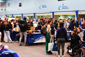Crowd of students in sports hall with society stalls