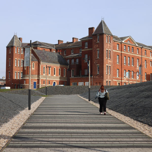 A student walking to City Campus