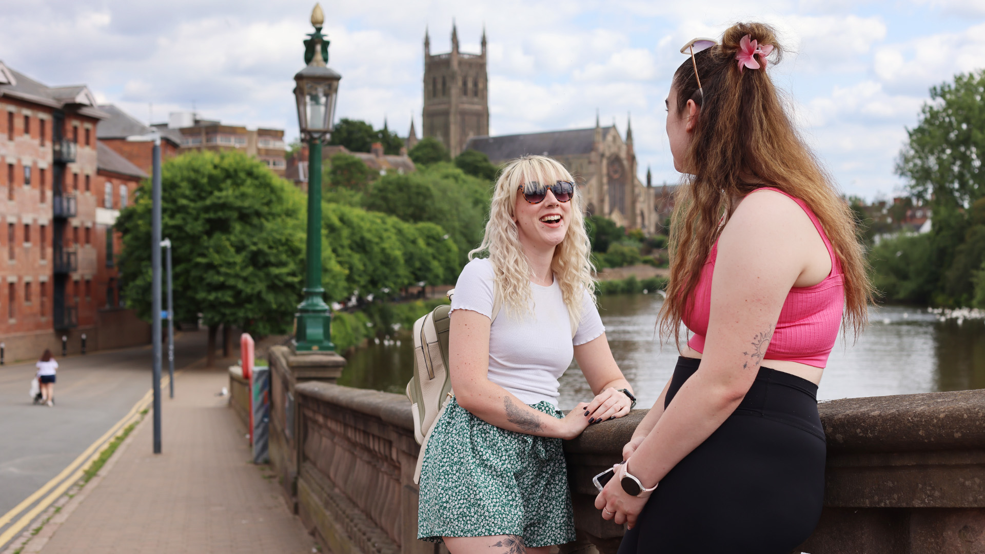 Students by the river in front of Worcester Cathedral