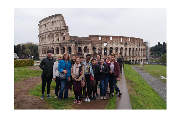 Students pose in front of the Colosseum