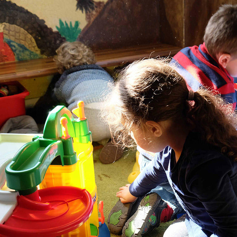 Young children playing with colourful toys