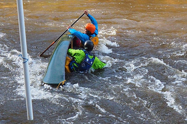 Outdoor Adventure students canoe righting in rapids