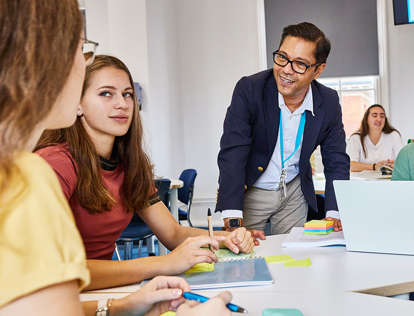 A lecturer speaking to two students