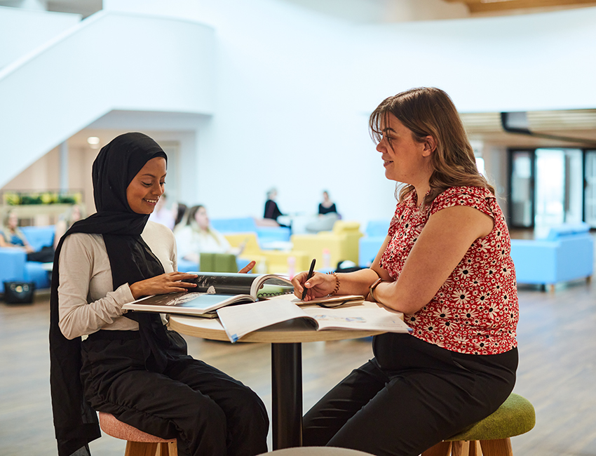 Two students talking and studying together