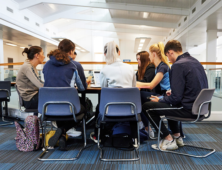 Digital marketing students gathered around the table