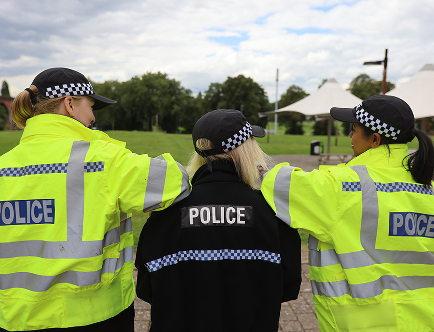 Three Professional Policing students facing away from the camera, looking into the distance