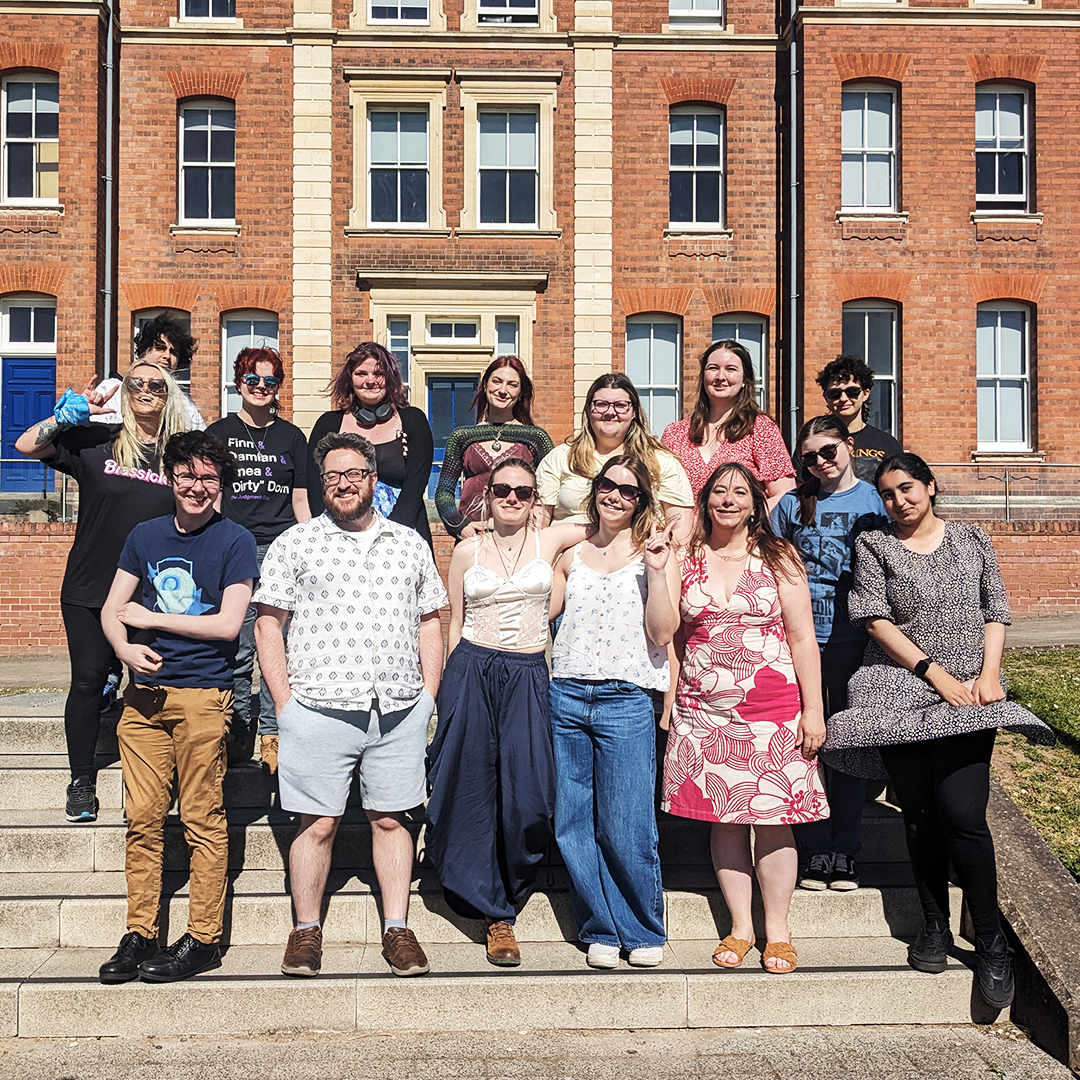 a group of students, stood with their lecturers