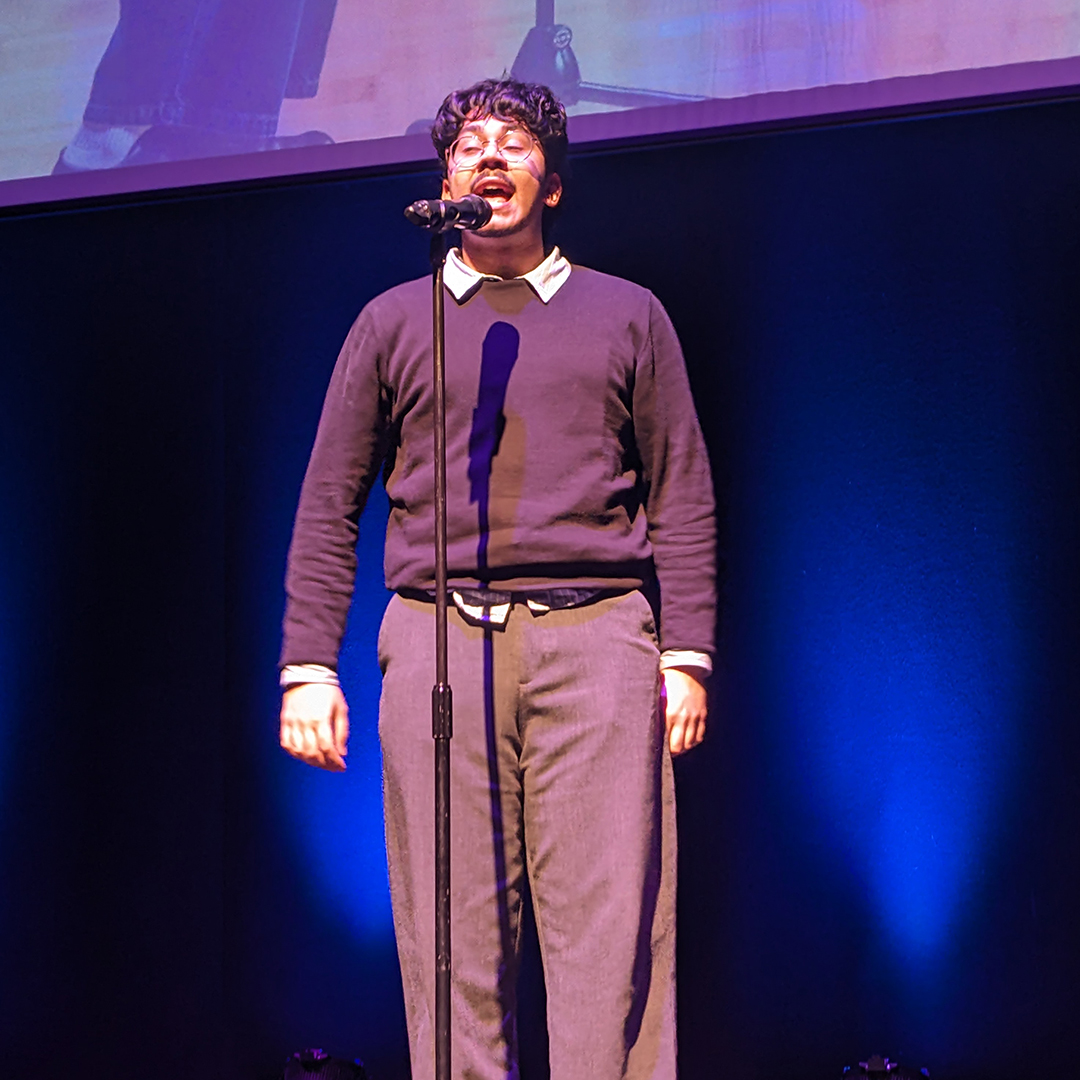 a student talking in front of a microphone