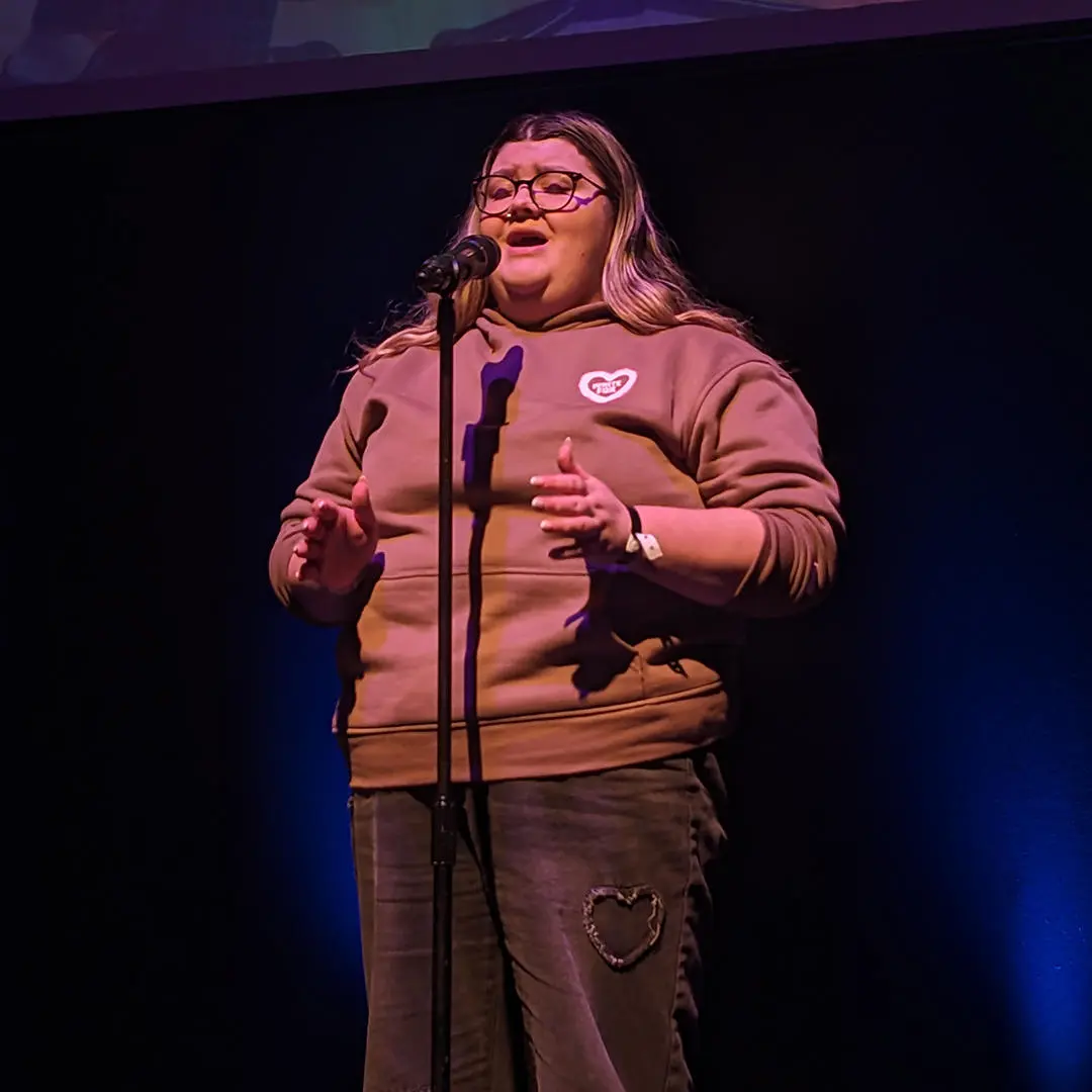 a student speaking into a microphone