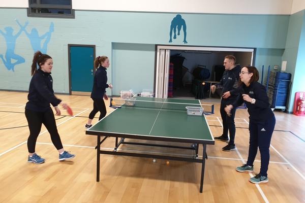 4 students playing table tennis