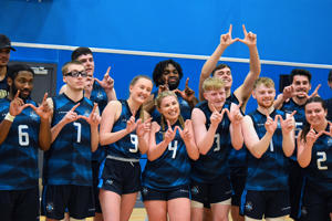 A group of sports students making the letter W with their fingers