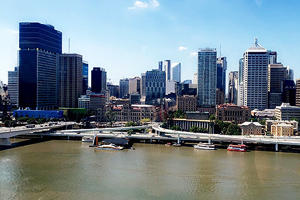 view of a river in the foreground and high rise buildings in the distance