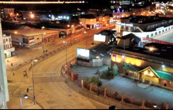 overhead view of a street at night with a number of bright lights