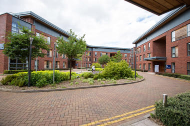 a bricked road in front of accommodation buildings